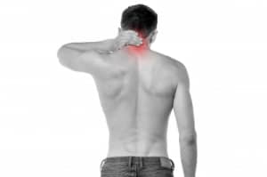 Man holding back of head in pain. Neck pain St Louis Precision Chiropractic