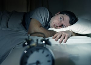 Man having trouble sleeping. St. Louis insomnia chiropractor Vital Force Clinic