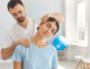 chiropractor adjusting neck and shoulders of patient