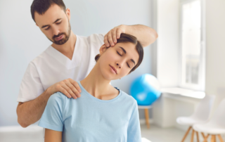 chiropractor adjusting neck and shoulders of patient